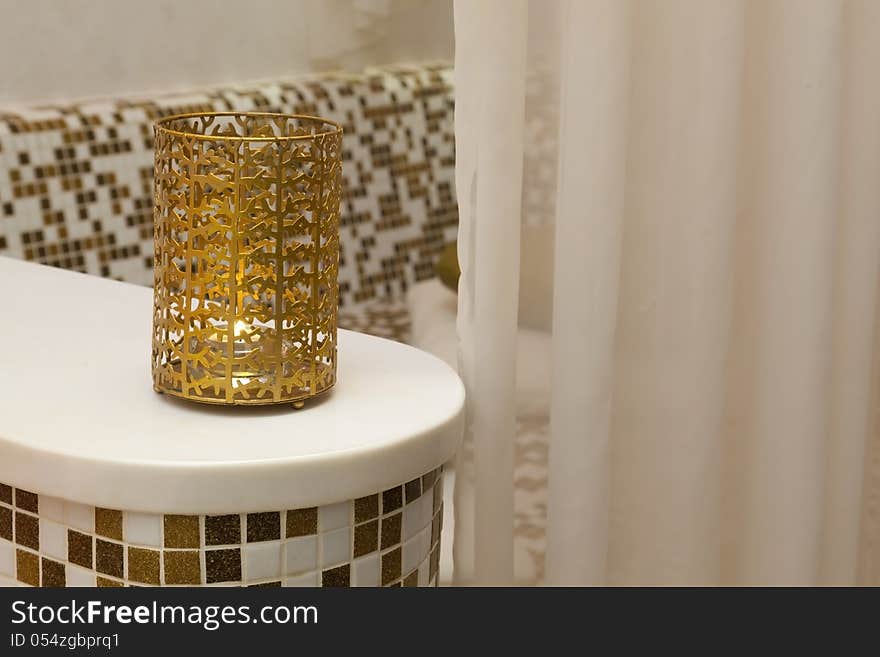 Golden candel flame in a mosaic SPA center. Golden candel flame in a mosaic SPA center