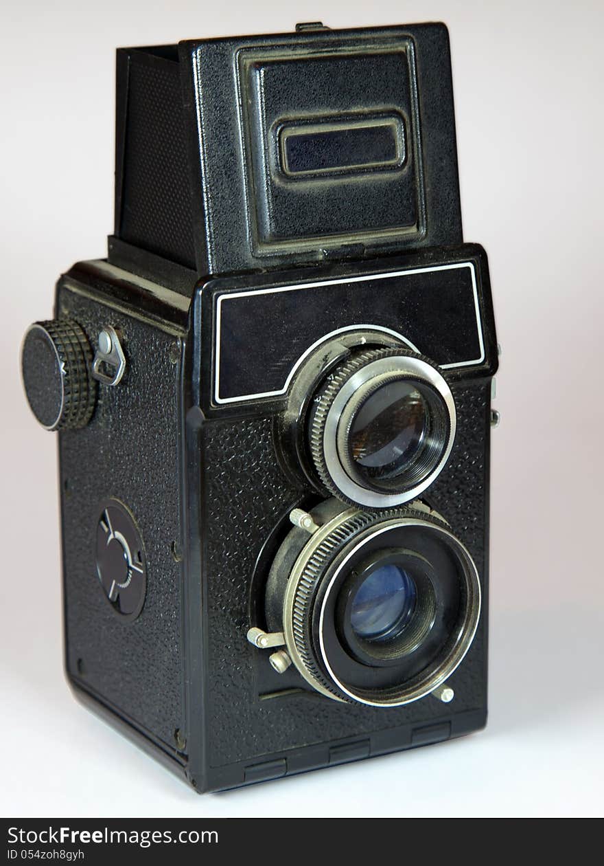 Old vitage camera with two lenses on light background