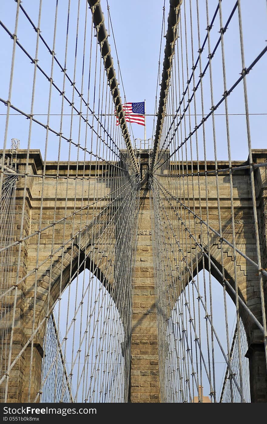 Upward image of Brooklyn Bridge in New York at sunny day