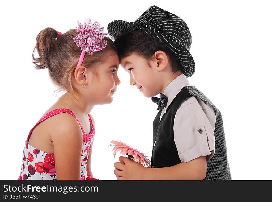 3-4 years Boy and girl looking at each other. The boy is holding a flower. Studio shot, white backgroud. 3-4 years Boy and girl looking at each other. The boy is holding a flower. Studio shot, white backgroud