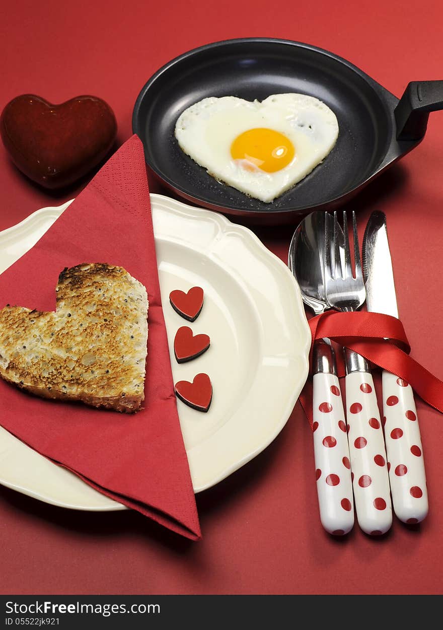 Red theme Valentine breakfast with heart shape egg and toast with love hearts on red background. Red theme Valentine breakfast with heart shape egg and toast with love hearts on red background.