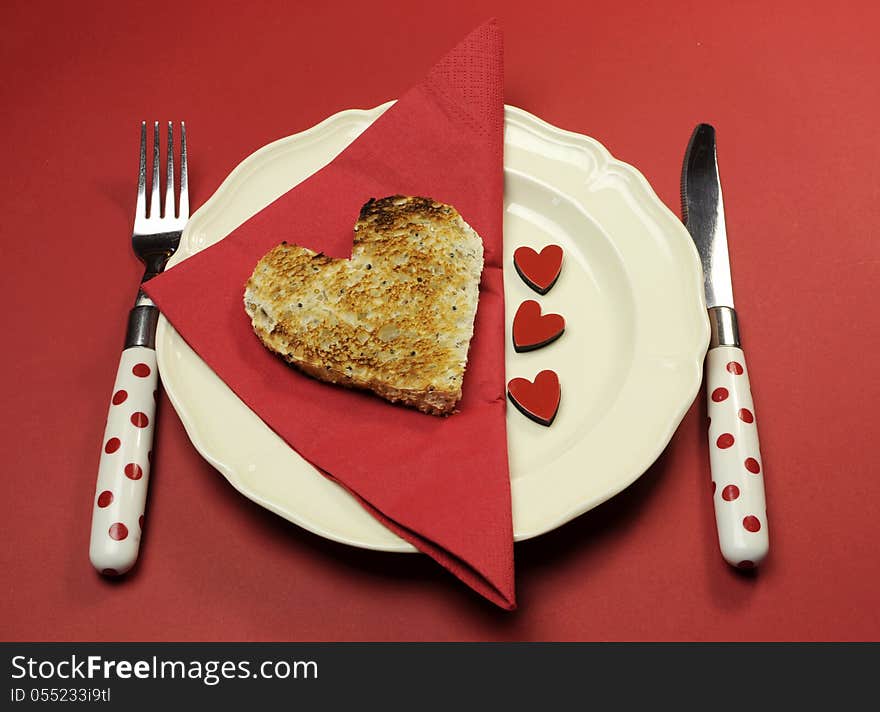 Red theme Valentine breakfast with heart shape toast with love hearts on red background. Red theme Valentine breakfast with heart shape toast with love hearts on red background.