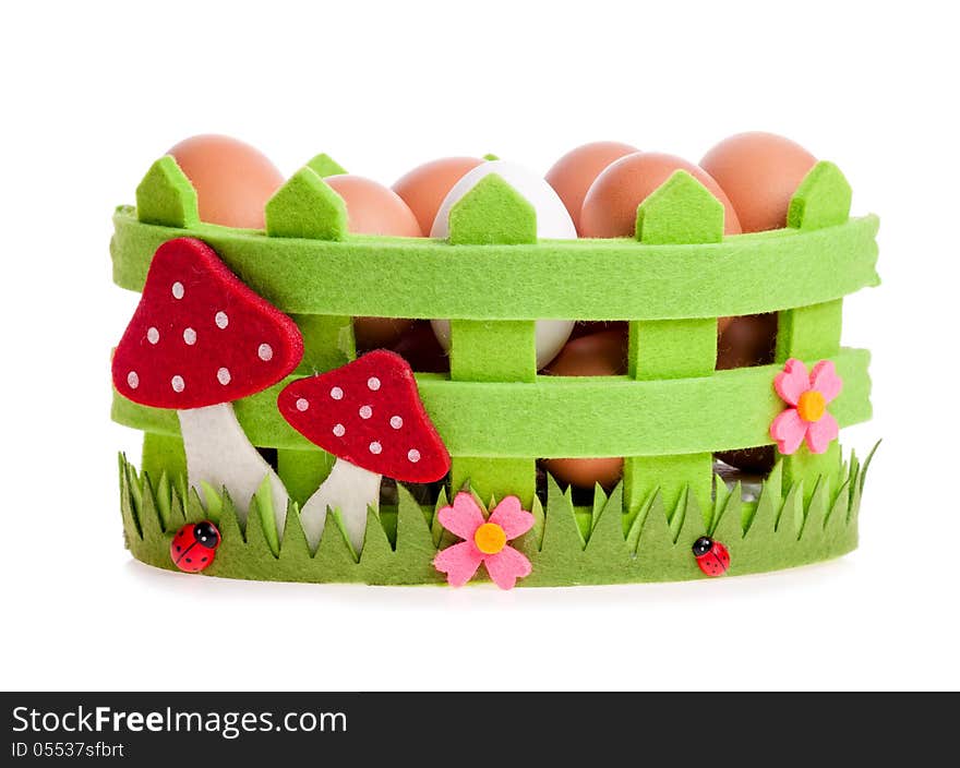 Chicken eggs in the green decorative basket