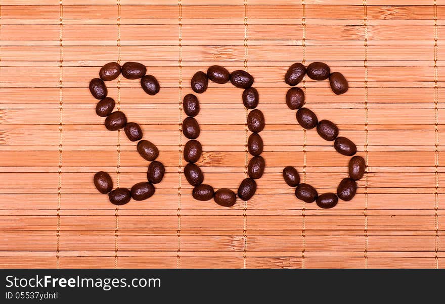 SOS From Coffee Beans On A Decorative Straw