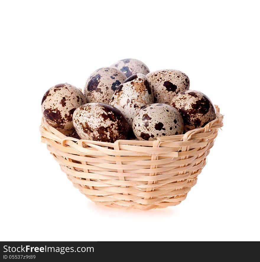 Quail eggs in a basket on the white