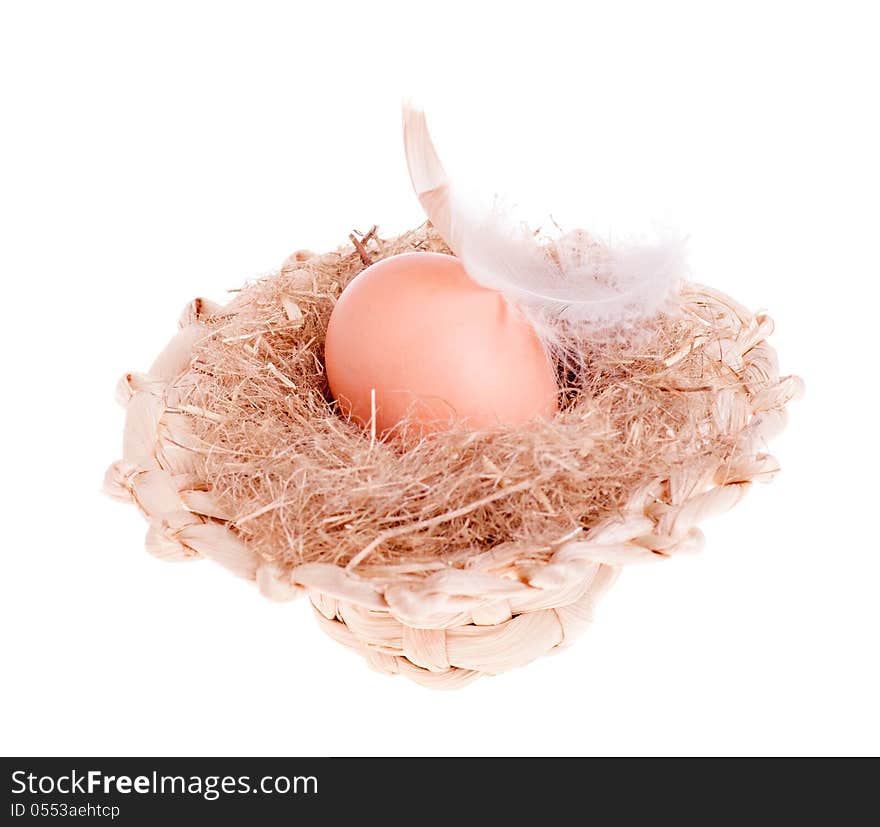 Yellow of the egg with a feather in a straw hat