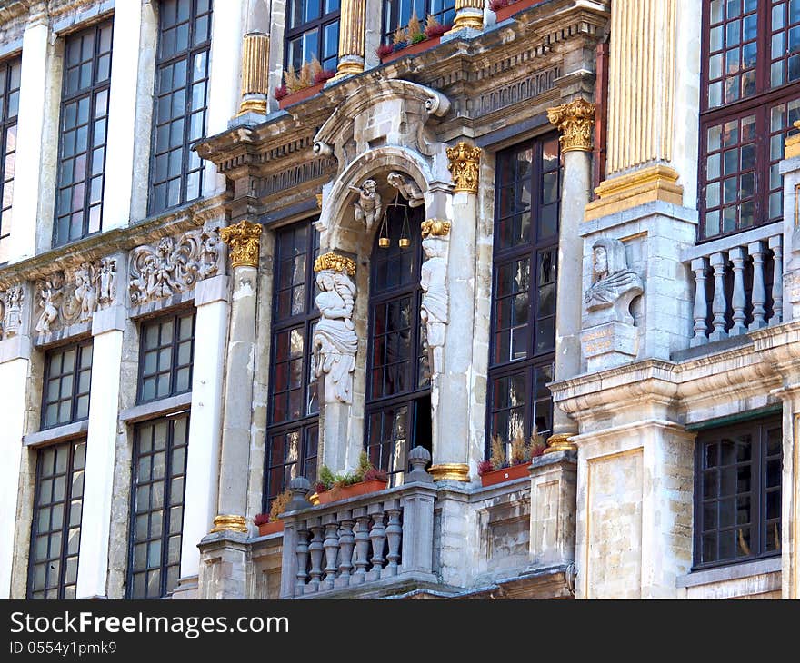 Grand Place In Brussels. Architectural detail at the Grand place statue on the balcony Belgium.