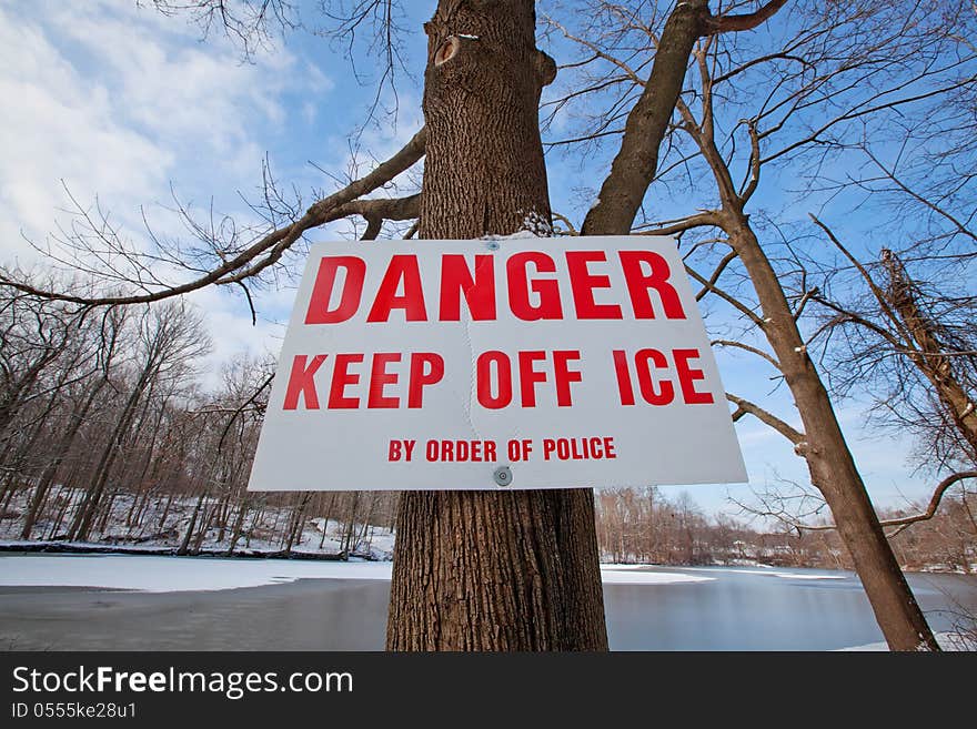 Warning sign to keep off the ice on the lake. Warning sign to keep off the ice on the lake