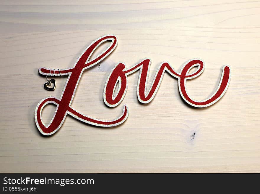 The Word, Love, Spelled In Red Script Letters On White Table, Close Up.