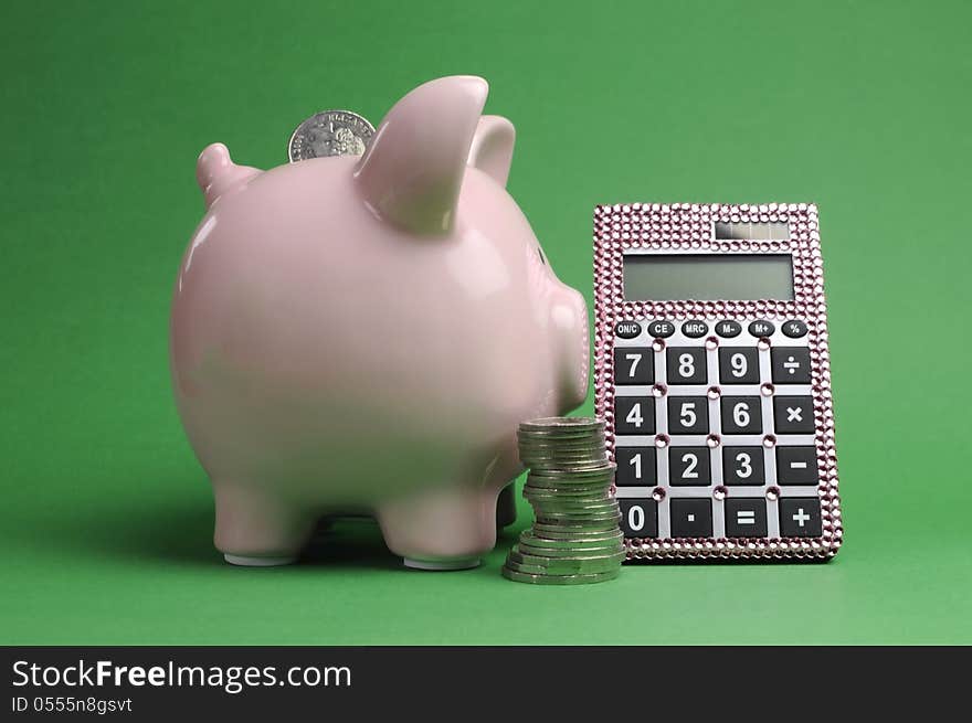 Savings and Shopping Sale concept with piggy bank, stack of coins and calculator against a green background.