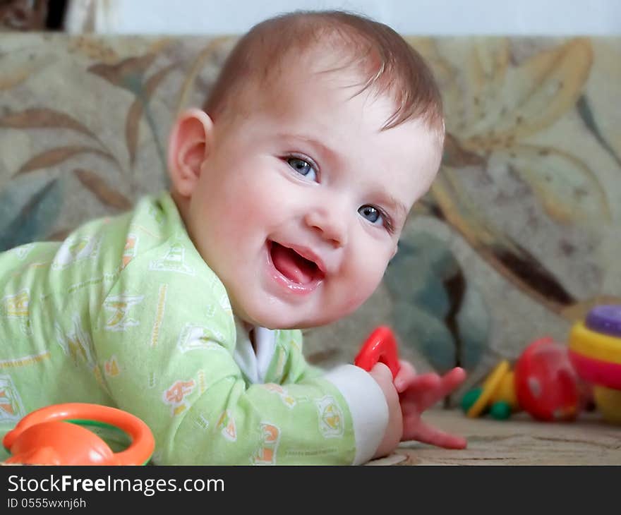 Smile of a Child with a toy in his hand. Smile of a Child with a toy in his hand