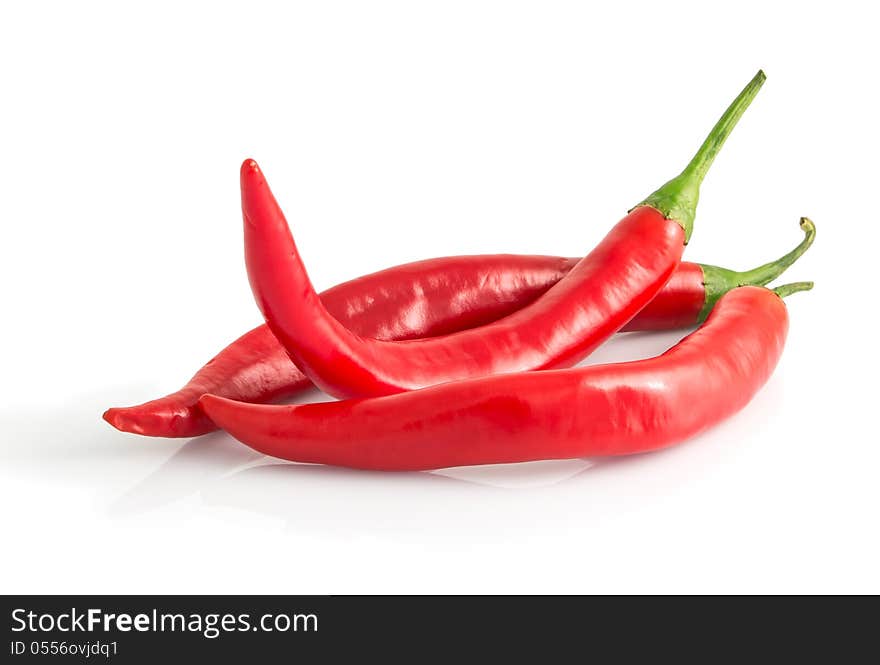 Three red hot peppers isolated on white background