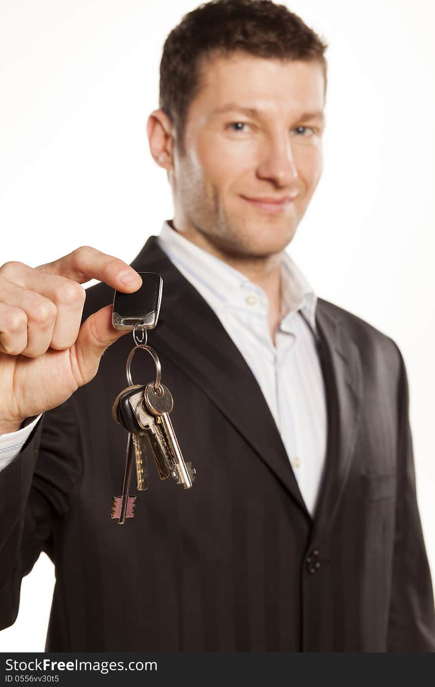 Handsome businessman gives a bunch of keys