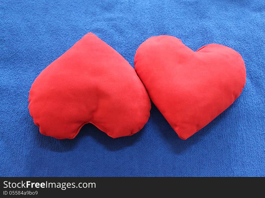 Red heart-shaped pillows - symbol of Valentines day.