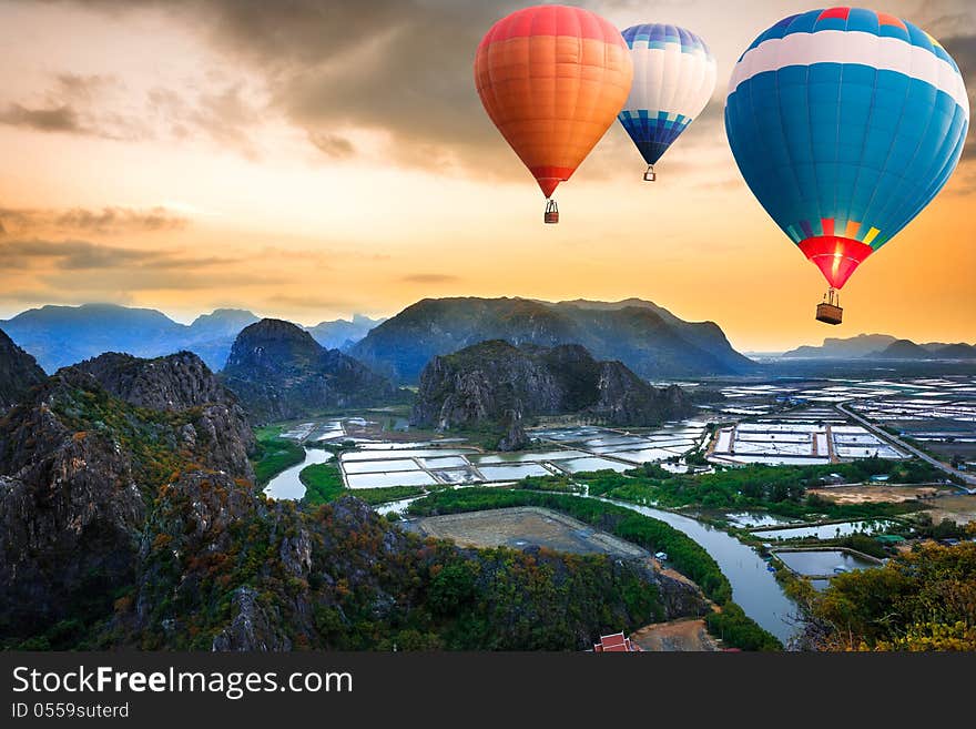 Hot air balloons floating up to the sky over mountain