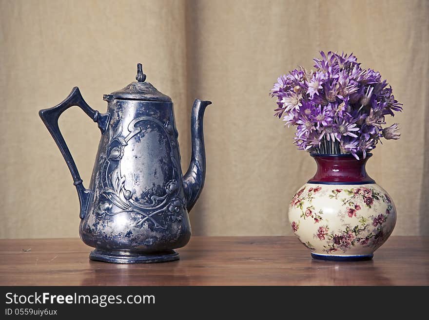 Sooty old teapot on old table in open old kitchen. Sooty old teapot on old table in open old kitchen