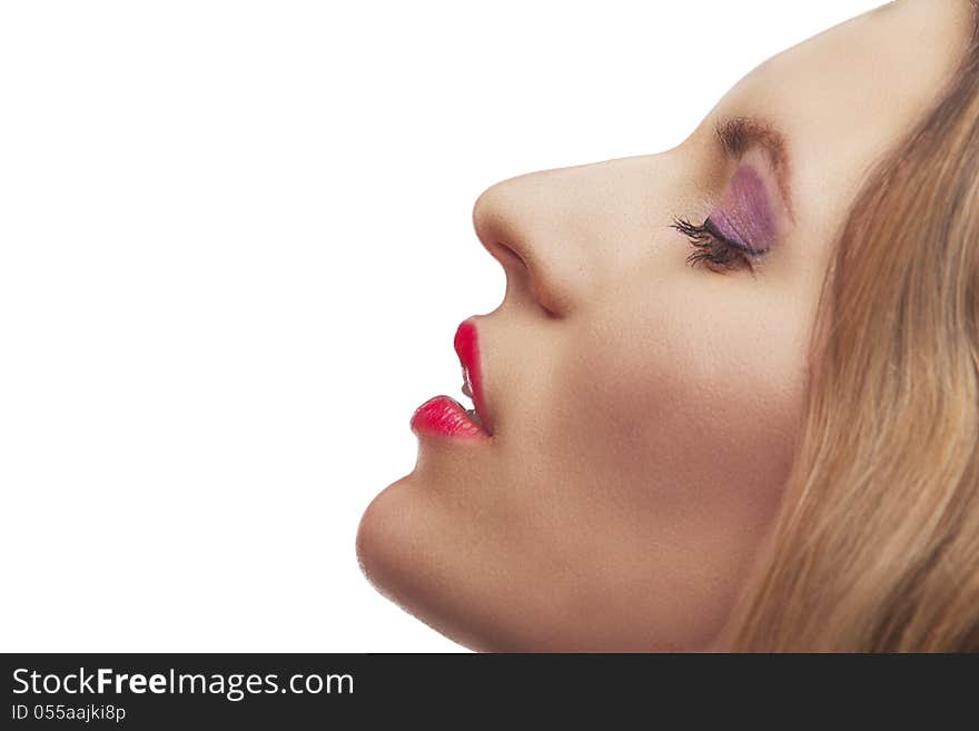 Closeup portrait of blonde young woman with fashion makeup