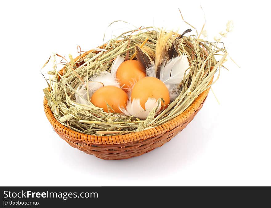 Brown eggs in wooden basket with hay and feather, food ingredient photo. Brown eggs in wooden basket with hay and feather, food ingredient photo