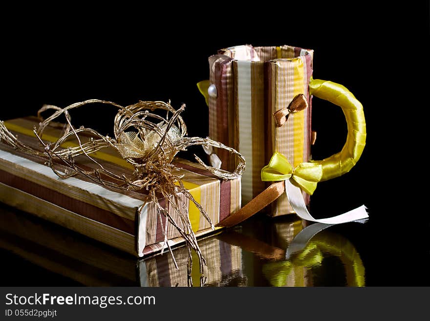 Paper gift box and paper mug on a black background