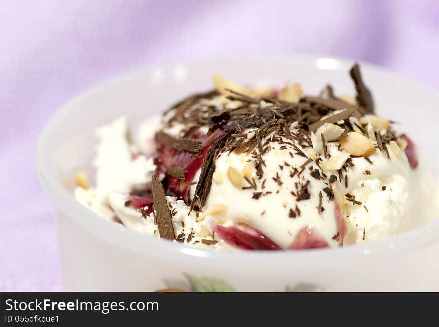 Dessert with cream, chocolate shaving, red jam and grated nuts. Dessert with cream, chocolate shaving, red jam and grated nuts