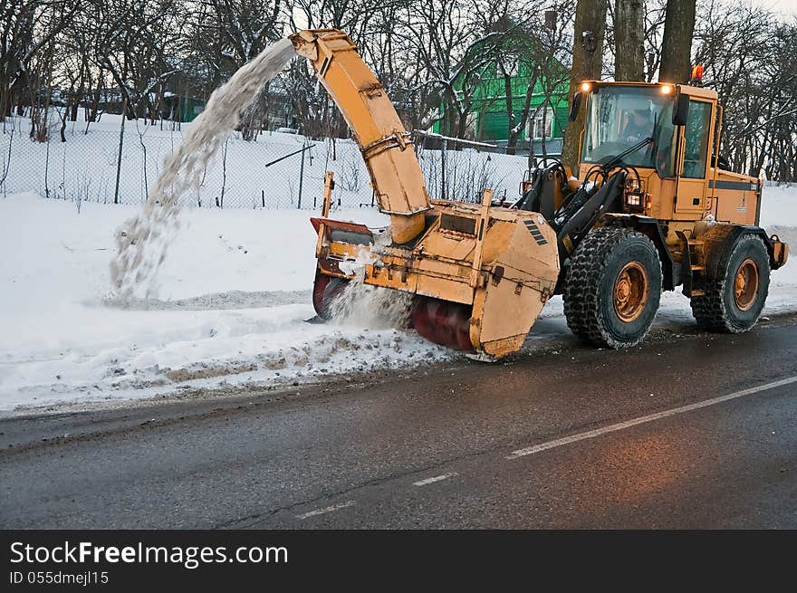 Snowblower at work on the side of the road