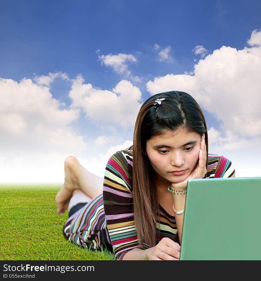 Woman using laptop and blue sky