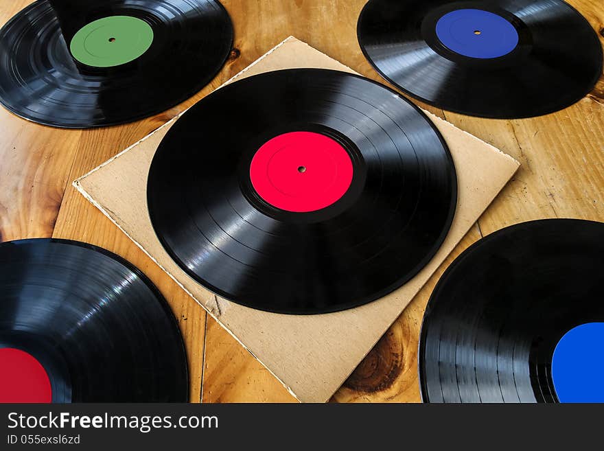 5 Lp's on a wooden table. 5 Lp's on a wooden table