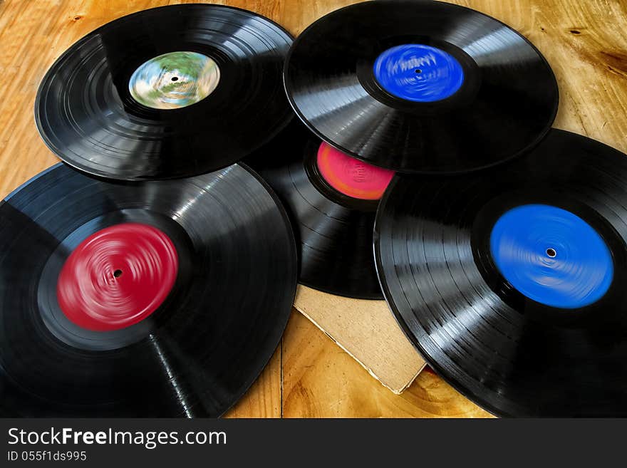 Stack of  Lp's on a wooden table. Stack of  Lp's on a wooden table