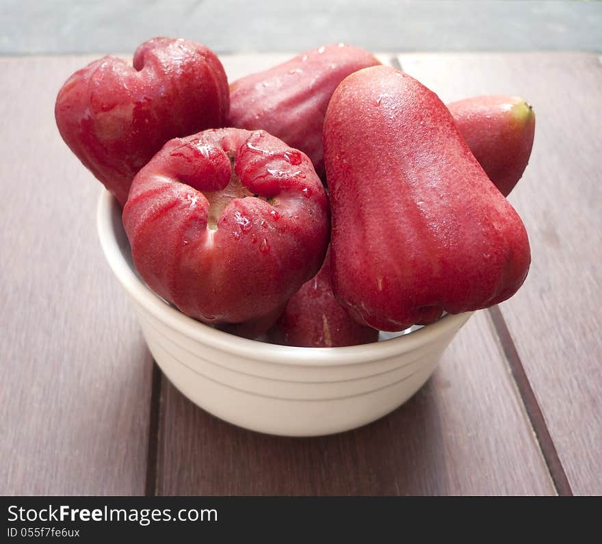 Red rose apple in a cup.