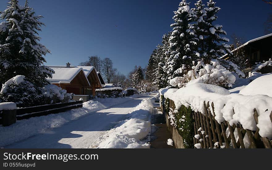 A sunny winter day in a residential neighborhood of the Bavarian village of Uffing on Lake Staffel. A sunny winter day in a residential neighborhood of the Bavarian village of Uffing on Lake Staffel.