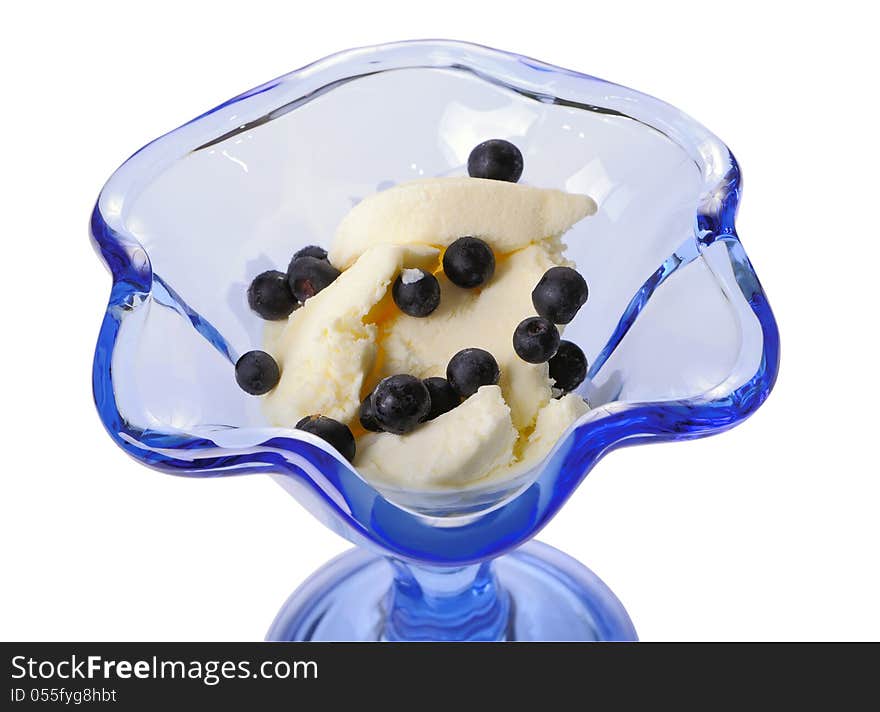 Ice cream with bilberry in a blue glass ice-cream bowl isolated on white