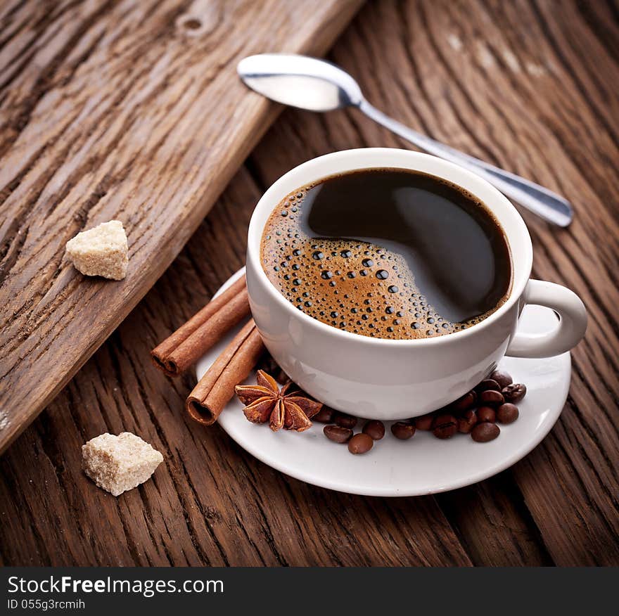 Cup of coffee with brown sugar on a wooden table. Cup of coffee with brown sugar on a wooden table.