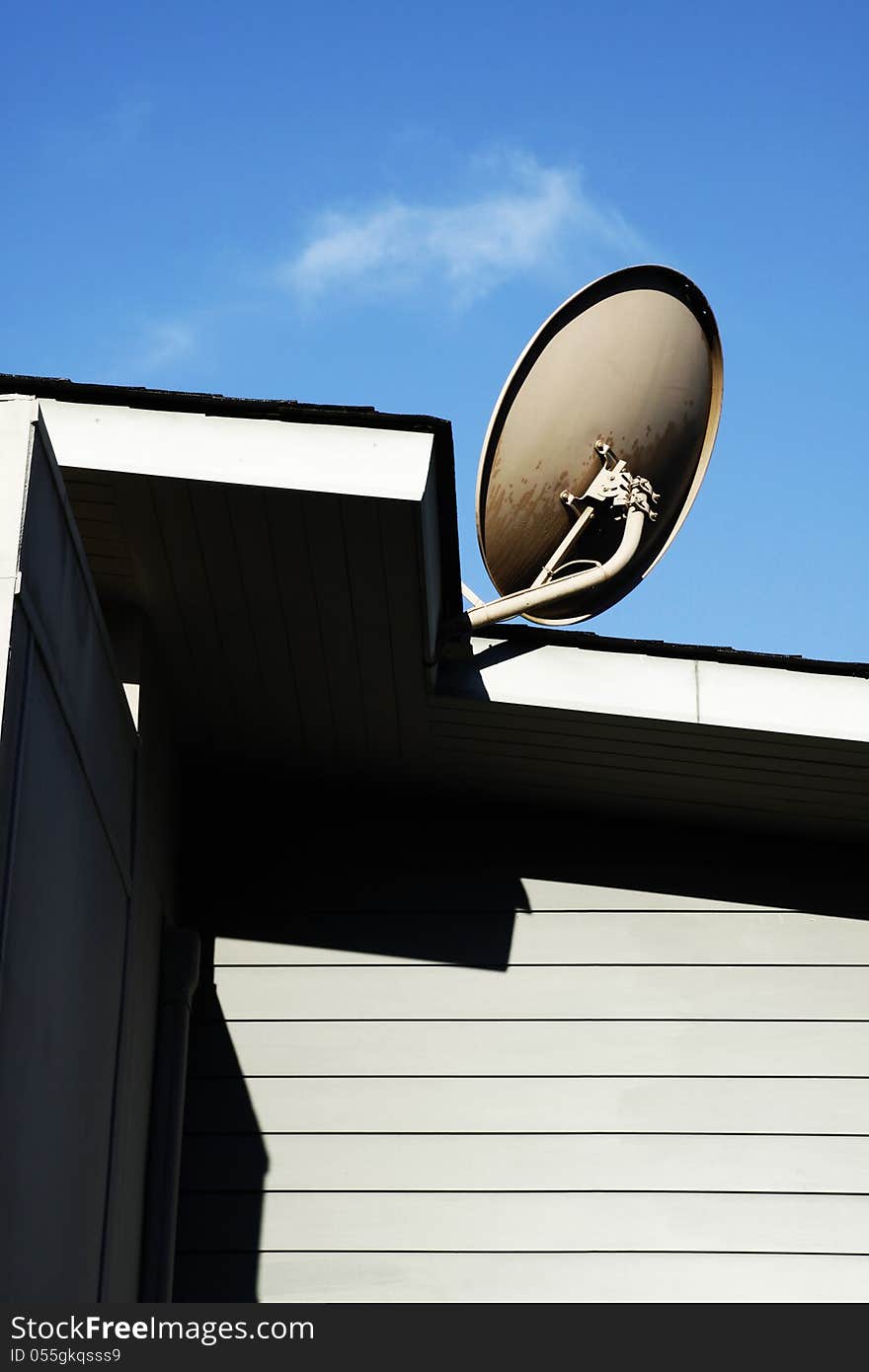 Satellite dish Antenna mounted on the roof with blue sky in the morning time