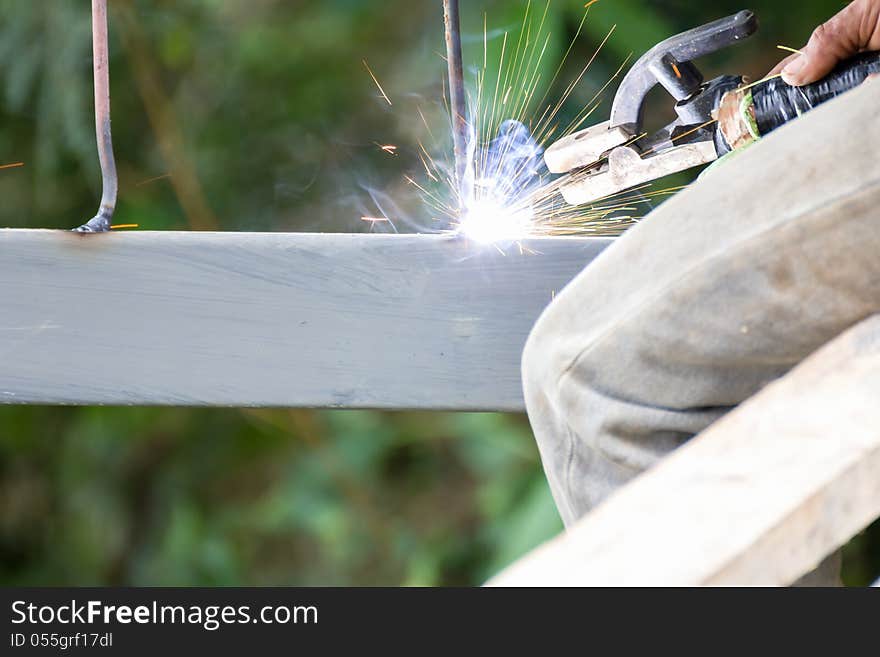 Welder welding elements at the construction site