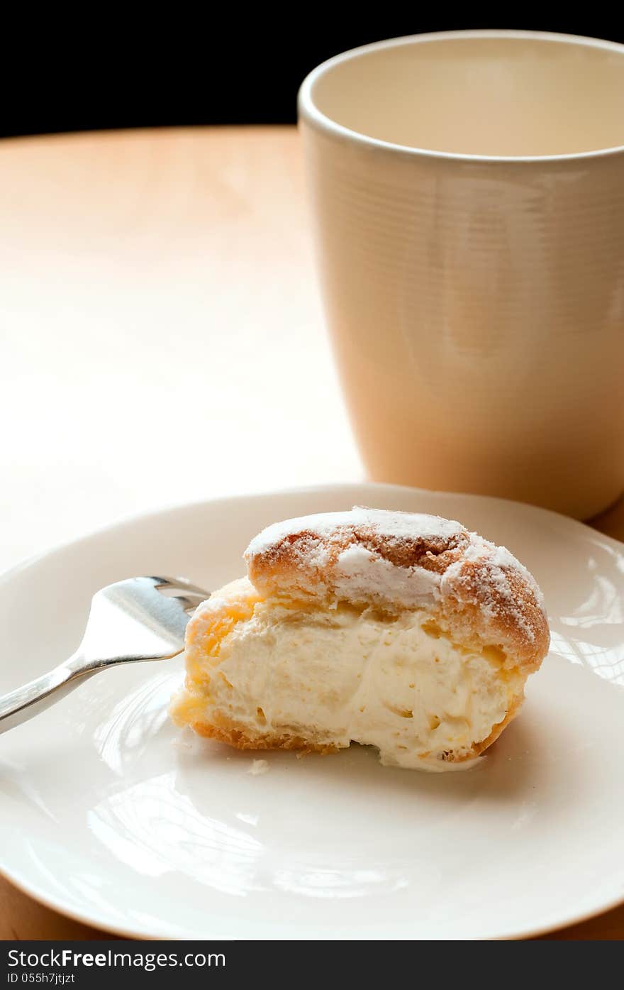 Choux pastry cream puffs on white plate. Choux pastry cream puffs on white plate