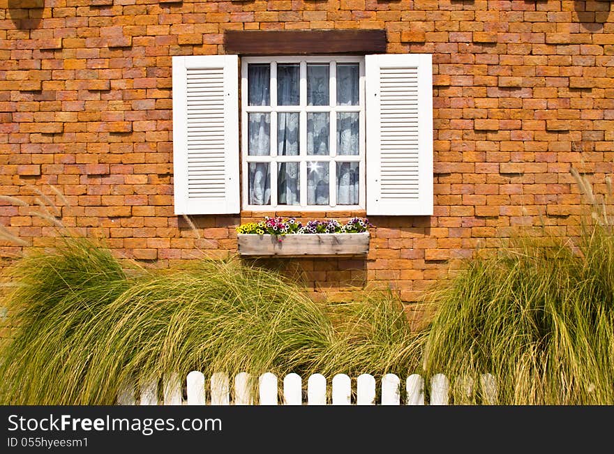 White window with brick wall