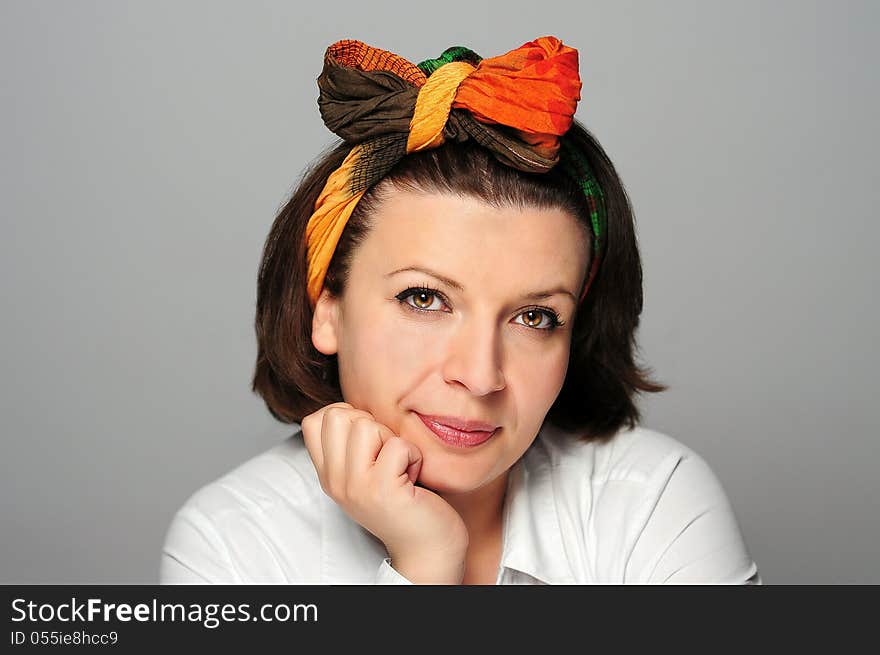 Girl with a colorful scarf in a studio