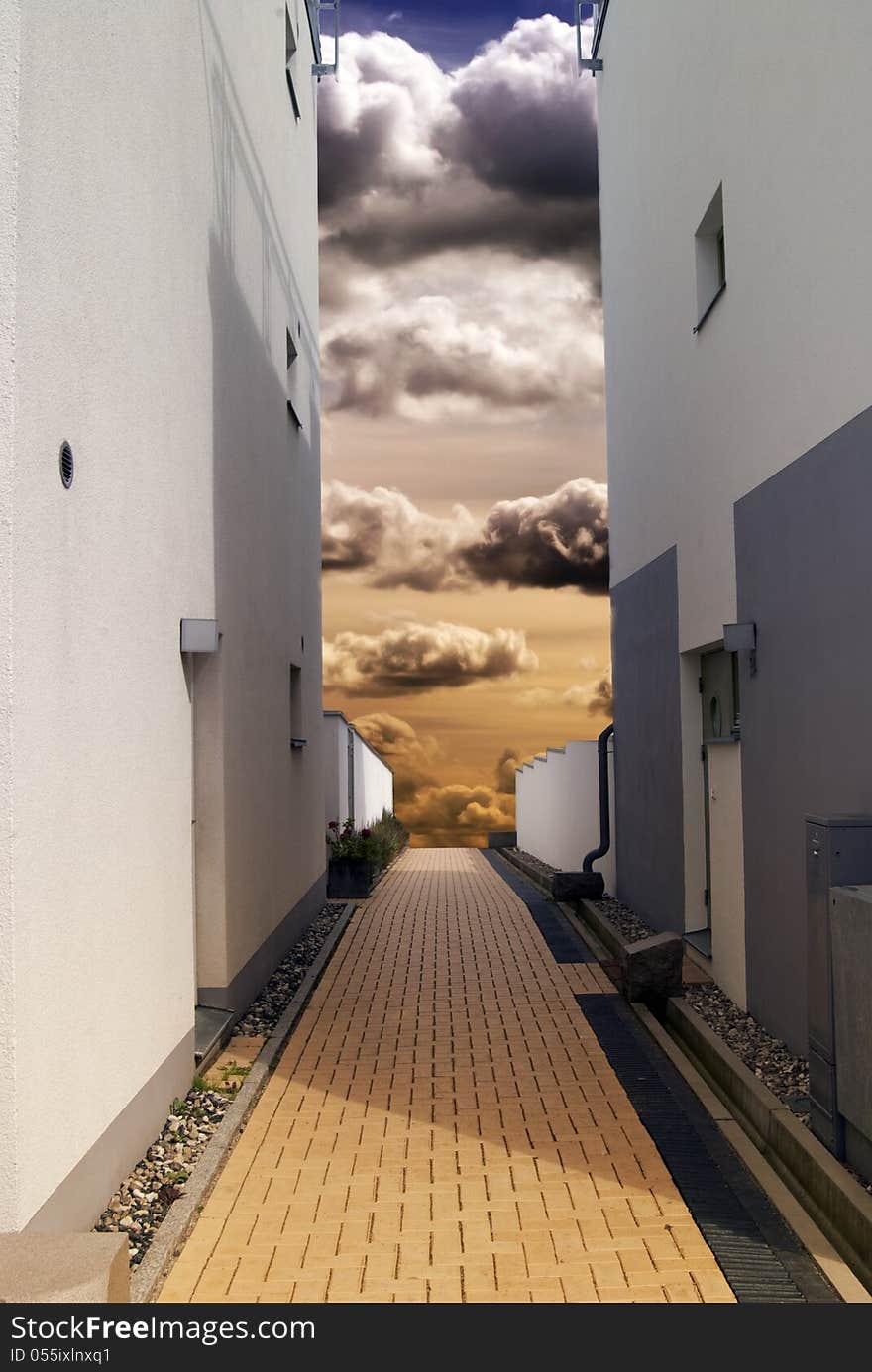 Alley with dramatic sky between the buildings. Alley with dramatic sky between the buildings