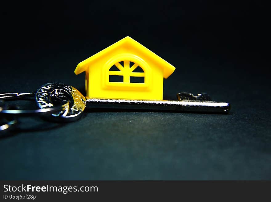 Keyring along side the home. Home and ring together to form a conceptual image. Keyring along side the home. Home and ring together to form a conceptual image.