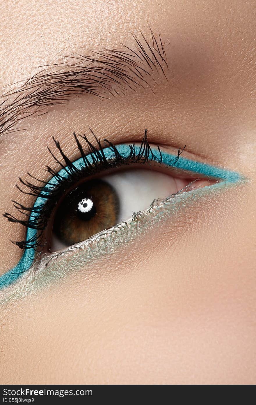 Cosmetics and beauty care. Macro close-up of beautiful green female eye with bright fashion make-up. Mint eyeshadows and black eyelashes. Cosmetics and beauty care. Macro close-up of beautiful green female eye with bright fashion make-up. Mint eyeshadows and black eyelashes