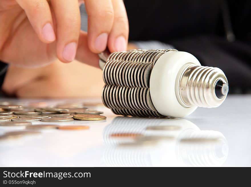 Abstract image of coin light bulb, energy concept