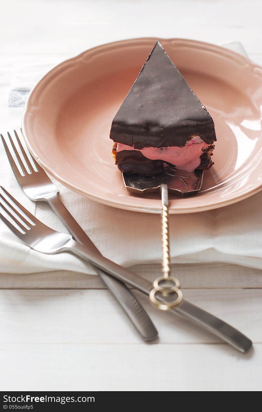 Piece of Chocolate Cake with Yogurt Cream from Raspberry on the Pink Plate. Piece of Chocolate Cake with Yogurt Cream from Raspberry on the Pink Plate