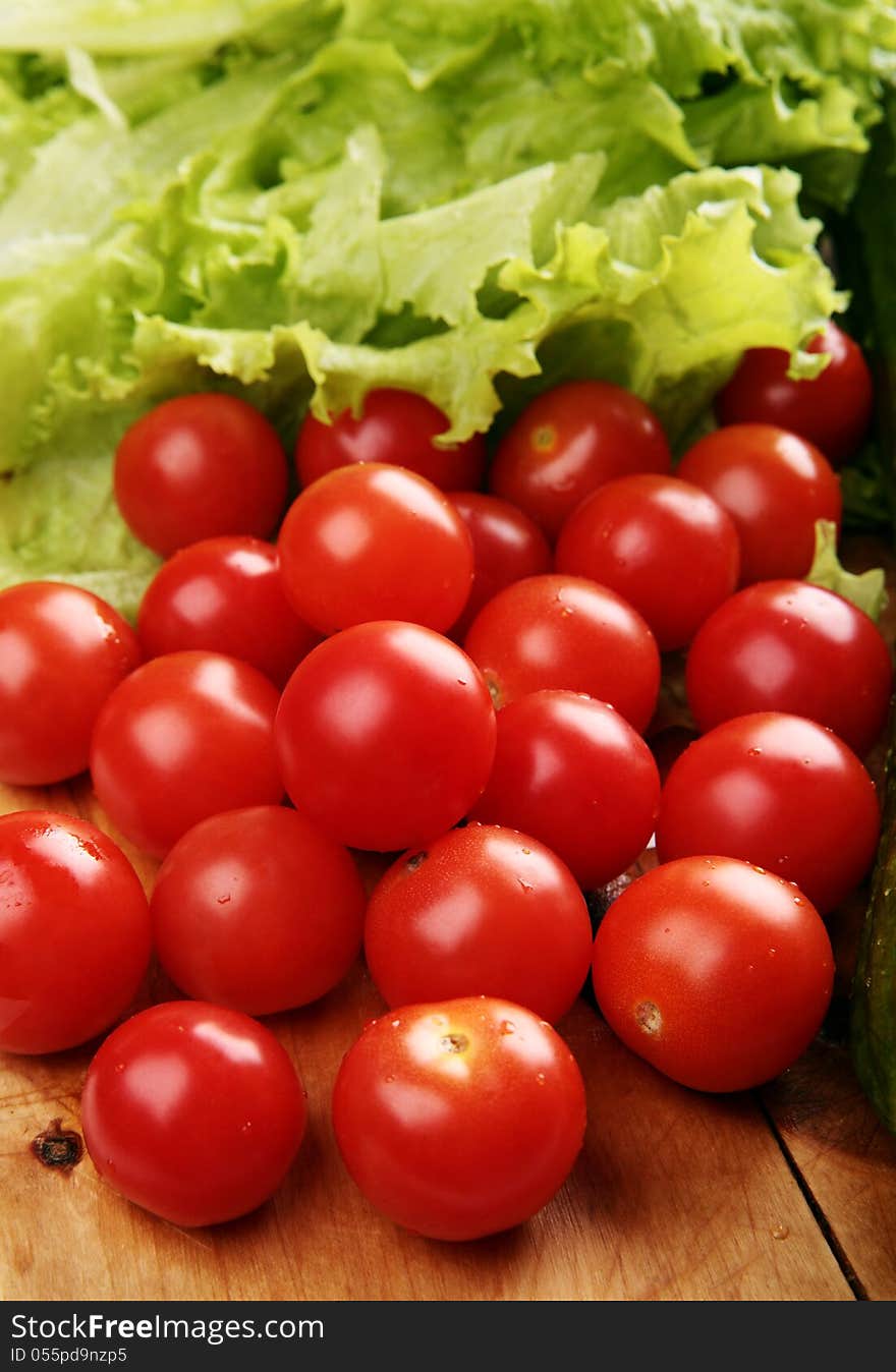 Red cherry tomatoes on a wooden board