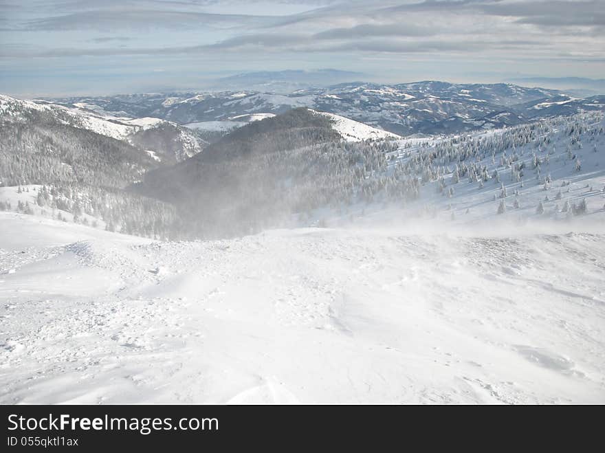 Winter landscape, windy day on the mountain