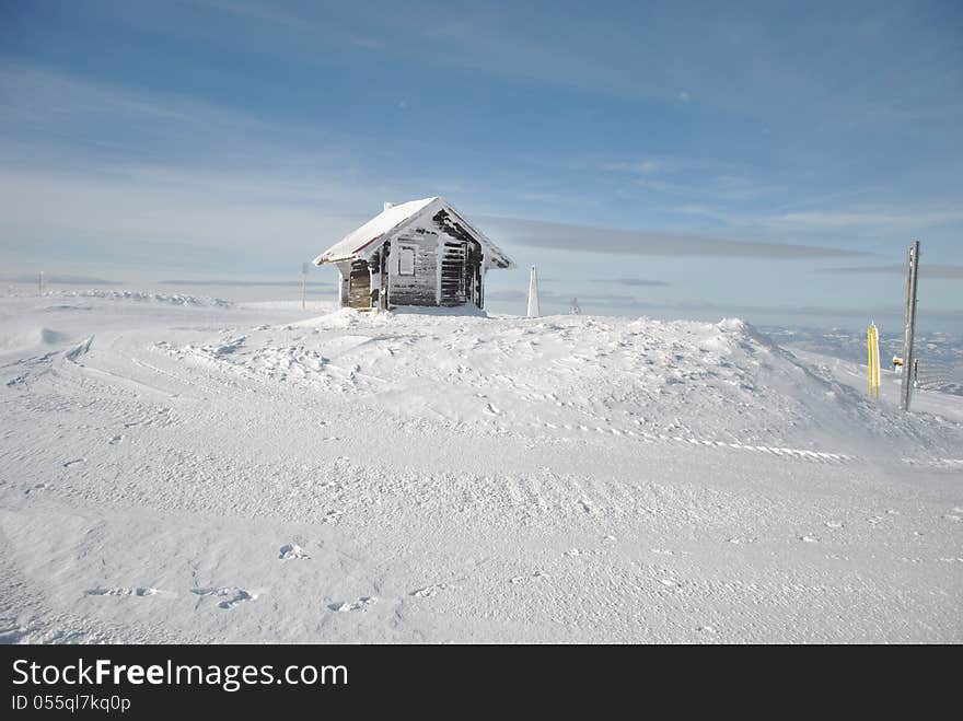 Winter mountain landscape with small shelter house and snowy pillars. Winter mountain landscape with small shelter house and snowy pillars