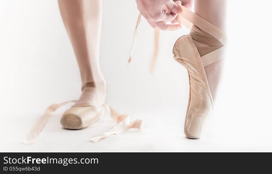 Ballet dancer preparing her dance shoes. Ballet dancer preparing her dance shoes