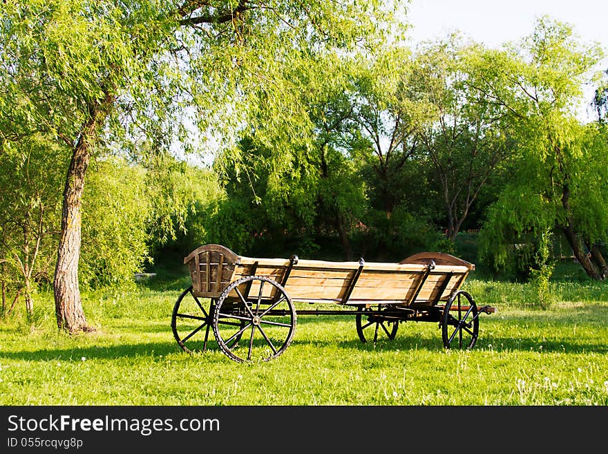 Cart among green grass landscape