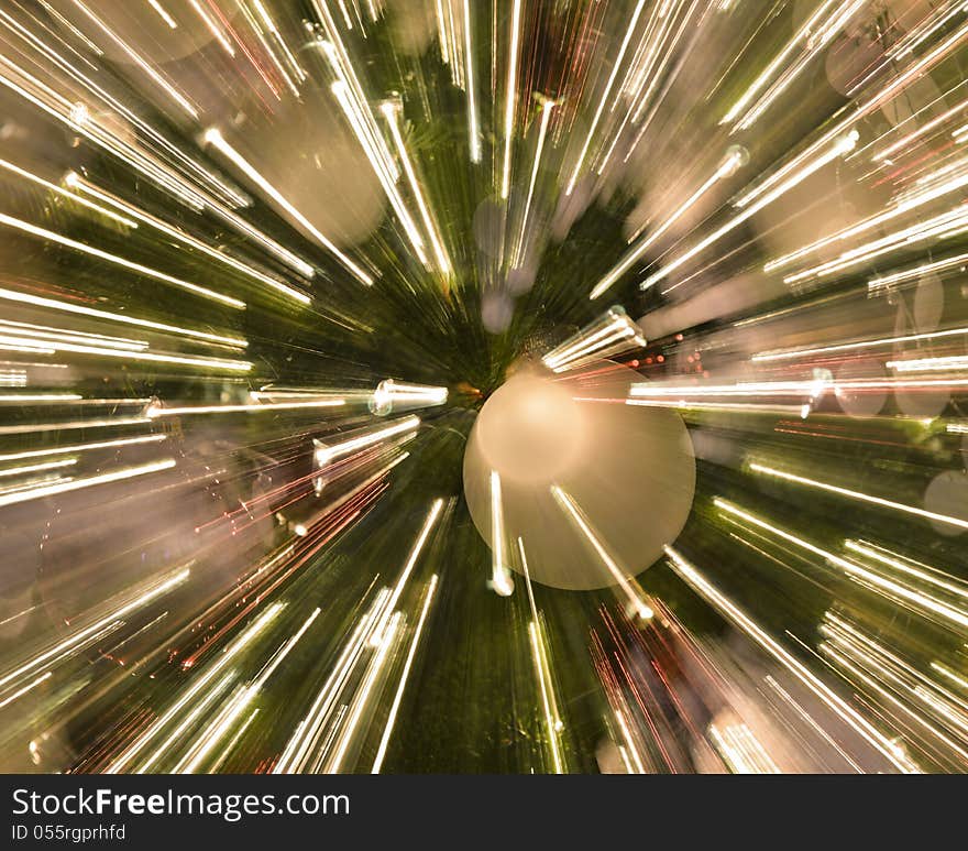 Zoomed in image of christmas holiday ornaments and lights with light streaks. Zoomed in image of christmas holiday ornaments and lights with light streaks