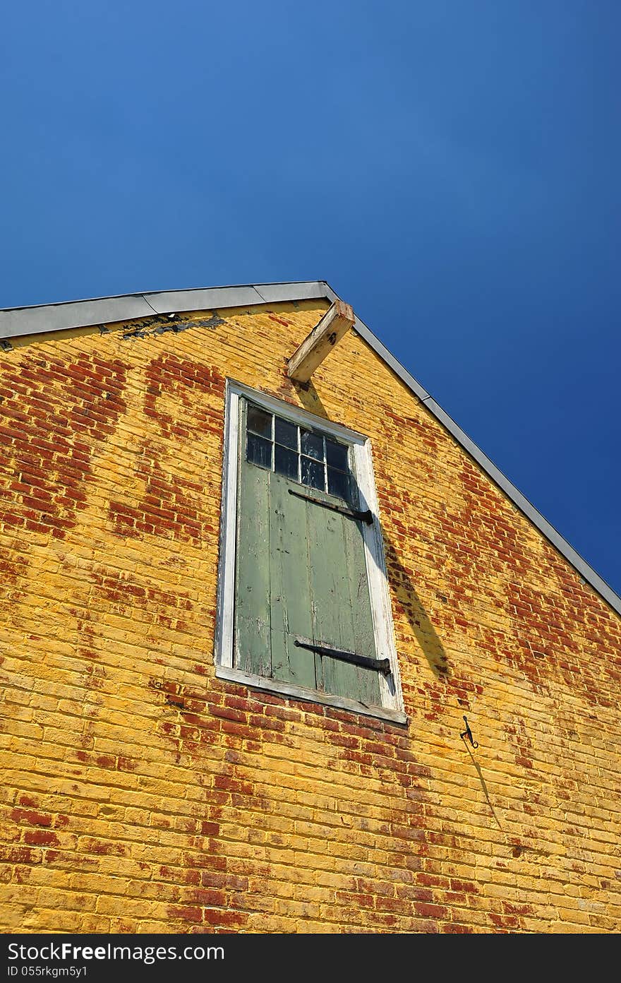 Colorful yellow and red brick historic structure against a blue sky. Colorful yellow and red brick historic structure against a blue sky