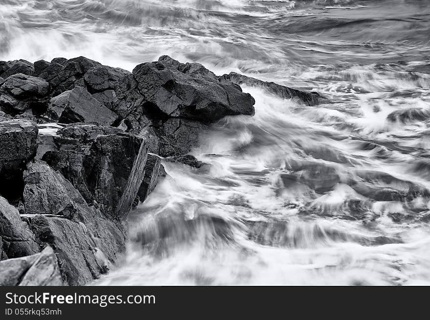 Waves crashing onto a rocky ledge